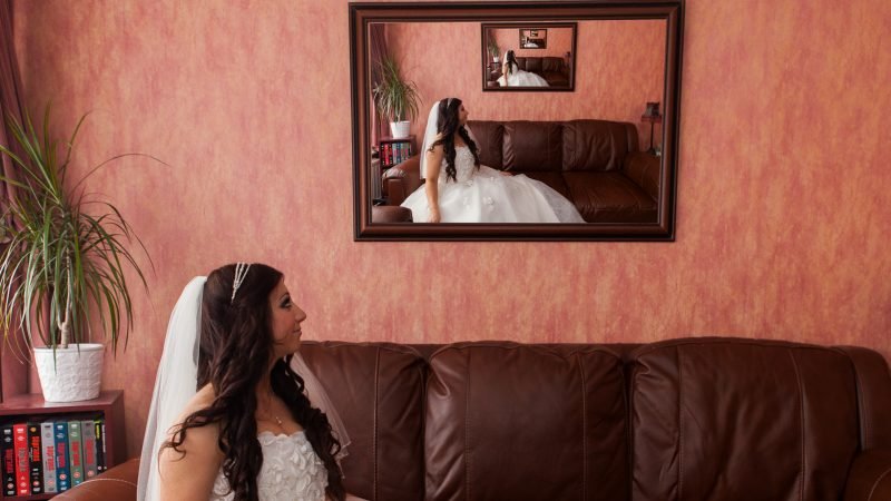 Ozgo Wedding Photography - Bride looking in the mirror illusion