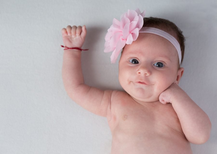 newborn baby with one hand up