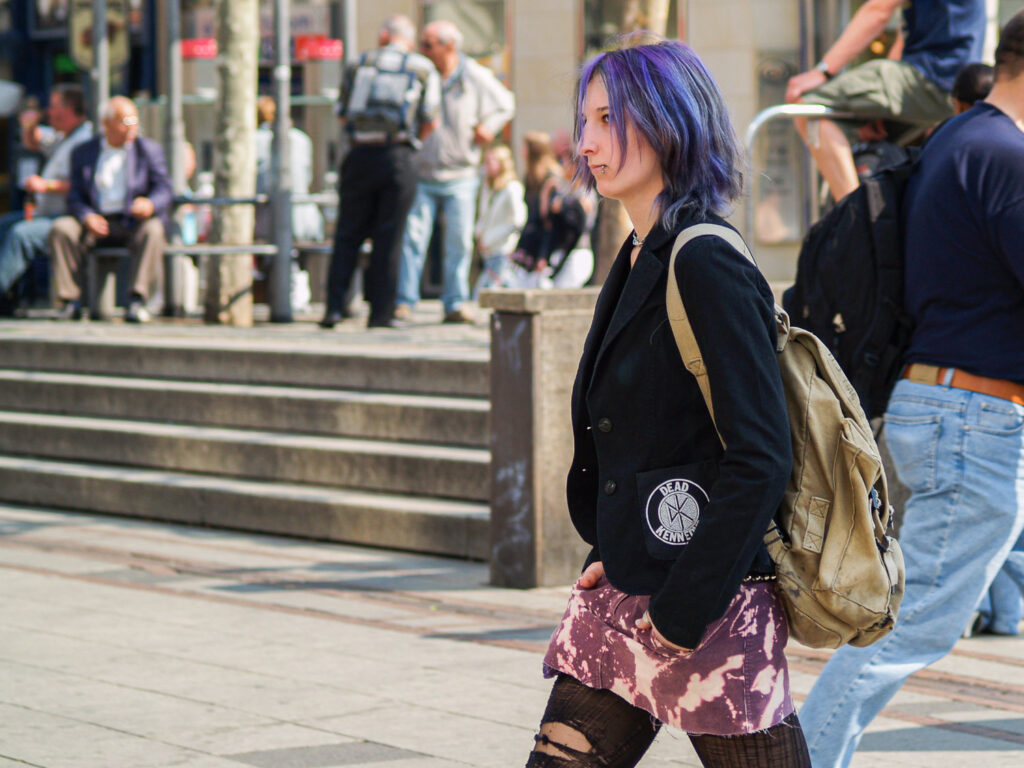 Young girl with purple hair walking in the street in Frankfurt