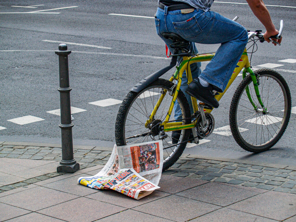 Newspaper stuck to a rear bicycle wheel